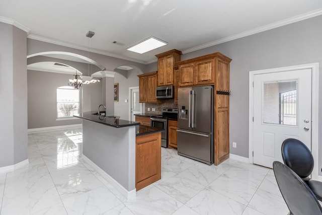 kitchen with dark countertops, brown cabinets, marble finish floor, stainless steel appliances, and a sink