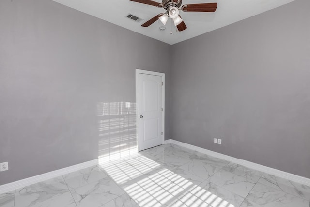 unfurnished room featuring marble finish floor, visible vents, ceiling fan, and baseboards