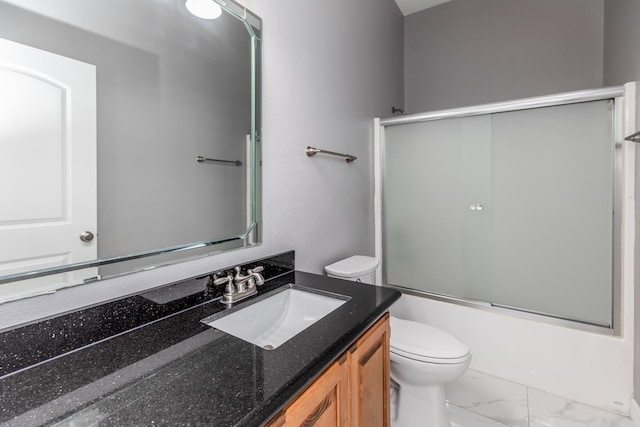 full bath with marble finish floor, shower / bath combination with glass door, vanity, and toilet