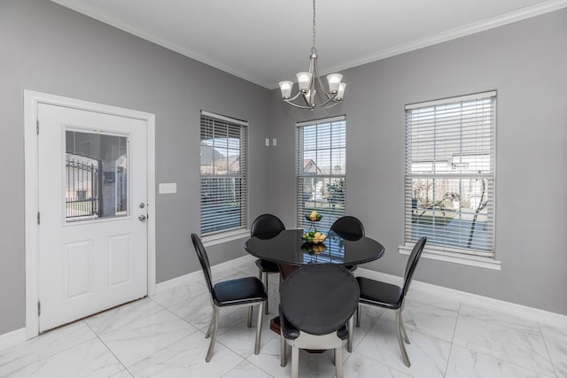 dining room with ornamental molding, marble finish floor, a notable chandelier, and baseboards