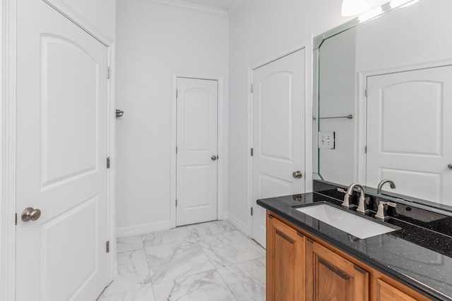 bathroom featuring baseboards, marble finish floor, vanity, and crown molding