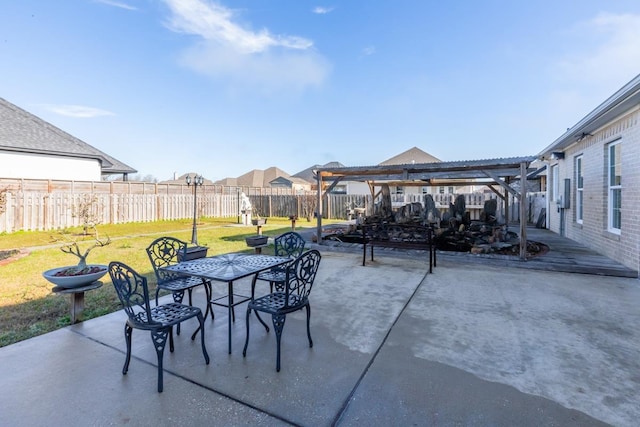 view of patio / terrace with a fenced backyard, a pergola, and outdoor dining space