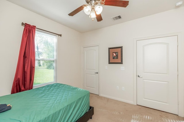 carpeted bedroom with ceiling fan