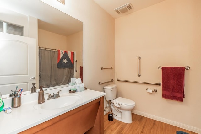 bathroom featuring hardwood / wood-style flooring, vanity, and toilet