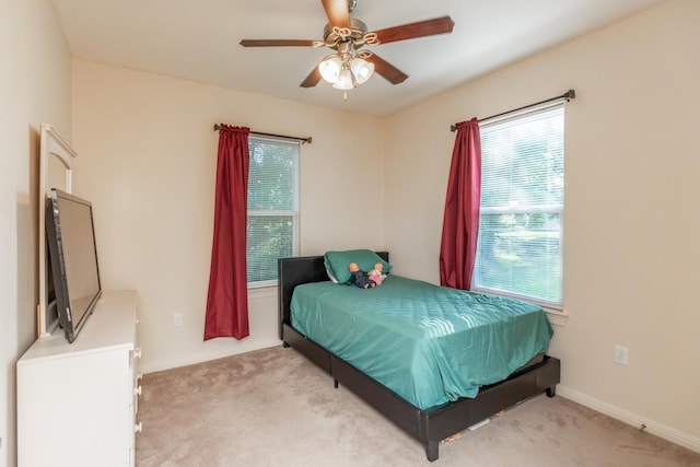 bedroom with light colored carpet and ceiling fan