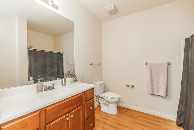 bathroom featuring hardwood / wood-style flooring, vanity, and toilet