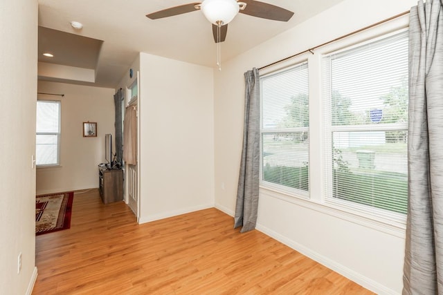 unfurnished room with ceiling fan and light wood-type flooring