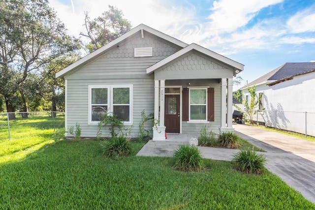 bungalow-style home with a front lawn