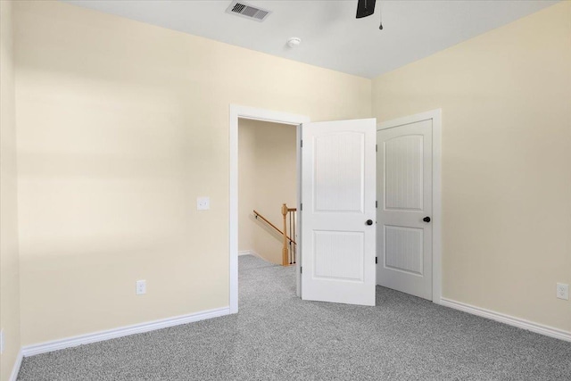 unfurnished bedroom with ceiling fan and carpet