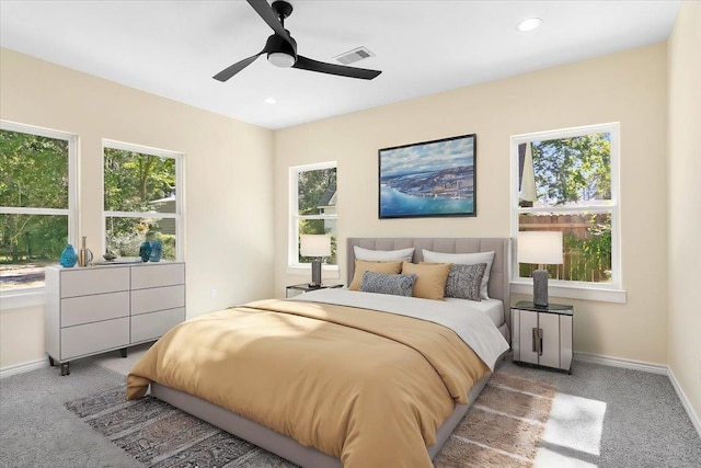 bedroom with ceiling fan and light carpet