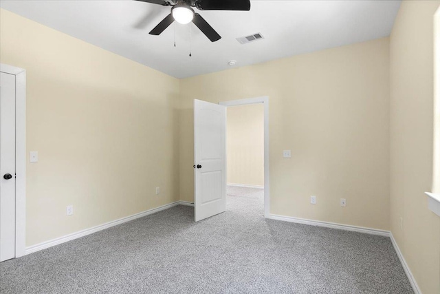 empty room featuring carpet floors and ceiling fan