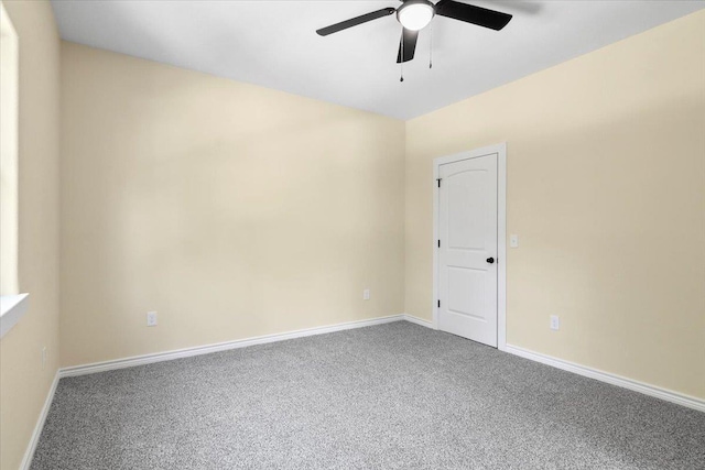 carpeted spare room with ceiling fan