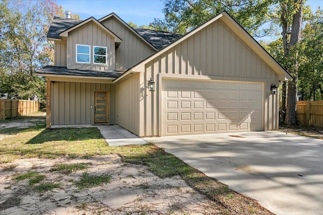 view of front of property featuring driveway, roof with shingles, fence, board and batten siding, and a garage