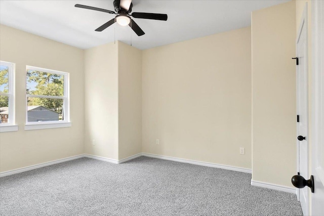 carpeted empty room featuring ceiling fan