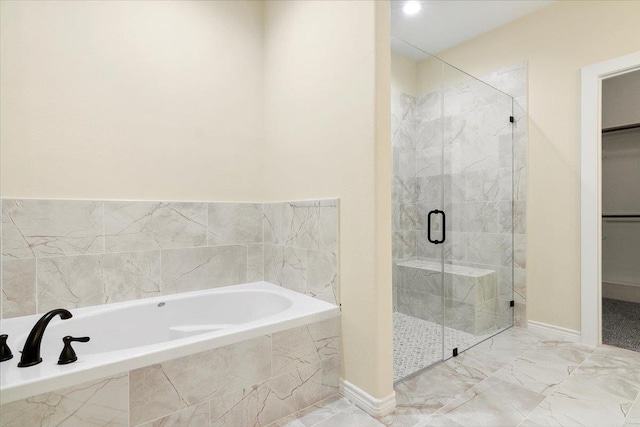 bathroom with separate shower and tub