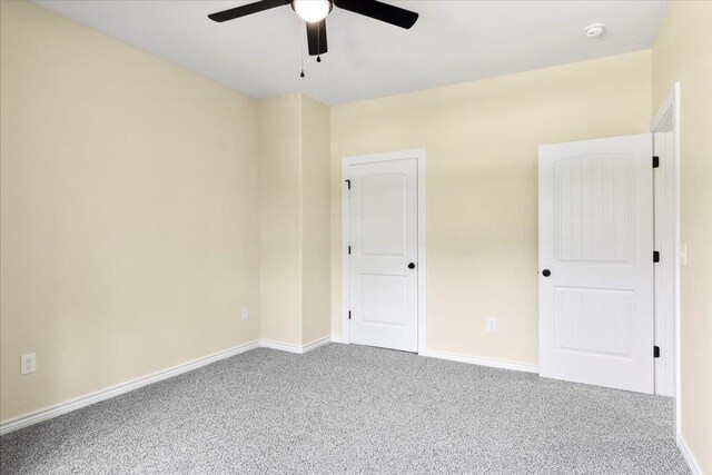 spare room featuring ceiling fan and carpet flooring