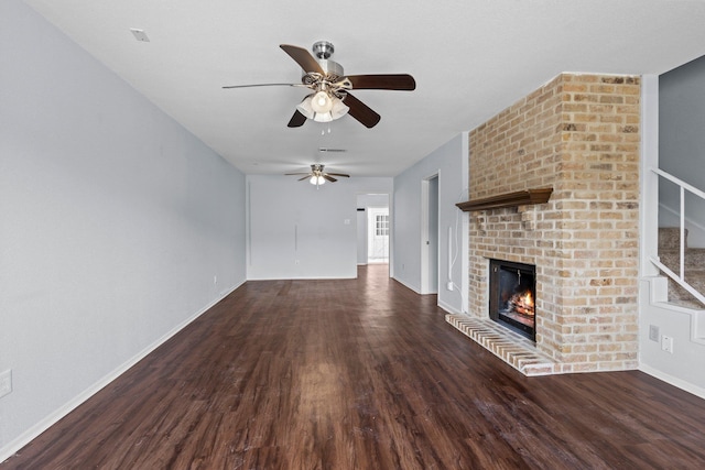 1003 Park Mdw, Beaumont, TX 77706 - unfurnished living room featuring ceiling fan, wood finished floors, a brick fireplace, and baseboards