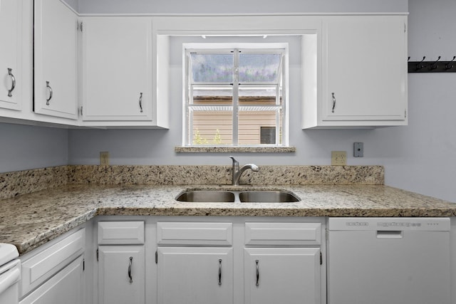1003 Park Mdw, Beaumont, TX 77706 - kitchen featuring dishwashing machine, a sink, and white cabinets