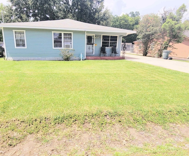2210 Nora St, Beaumont, TX 77705 - view of front facade featuring a porch, a front yard, and concrete driveway