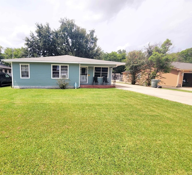2210 Nora St, Beaumont, TX 77705 - view of front of home with a porch, concrete driveway, and a front yard