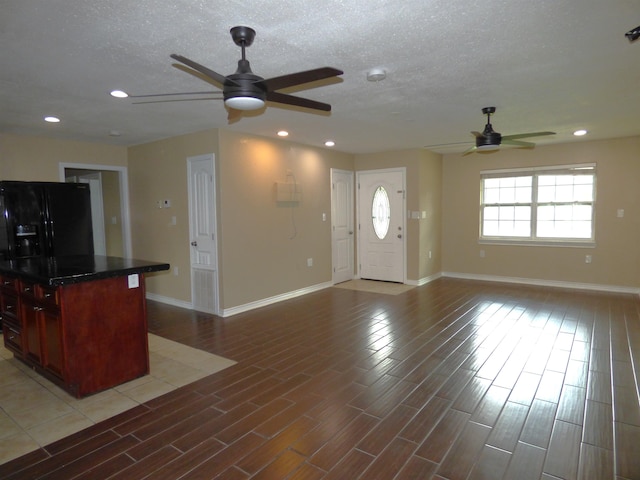 5335 Idylwood St, Beaumont, TX 77703 - unfurnished living room with a ceiling fan, baseboards, light wood-style flooring, recessed lighting, and a textured ceiling