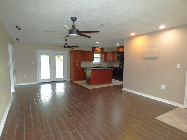 5335 Idylwood St, Beaumont, TX 77703 - unfurnished living room with baseboards, a ceiling fan, recessed lighting, a sink, and dark wood-style flooring