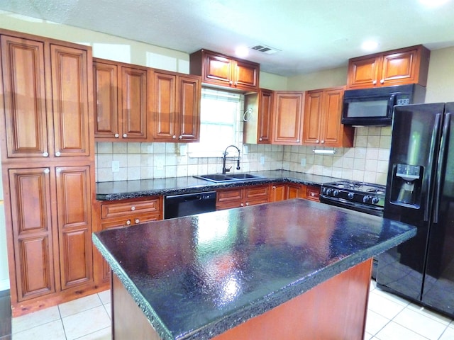5335 Idylwood St, Beaumont, TX 77703 - kitchen with black appliances, a sink, brown cabinetry, and light tile patterned floors
