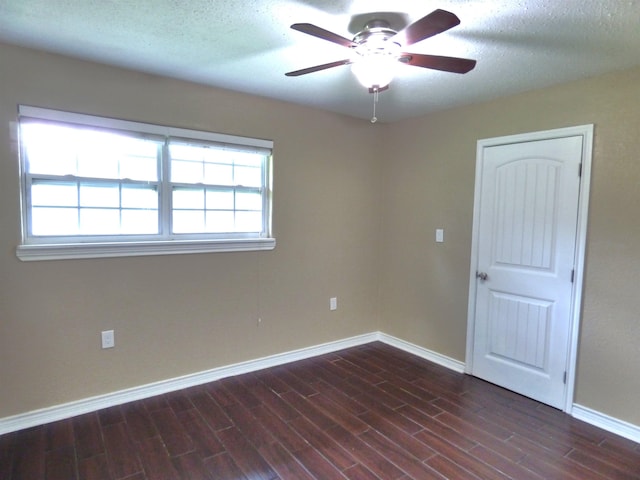 5335 Idylwood St, Beaumont, TX 77703 - spare room with baseboards, ceiling fan, dark wood-style flooring, and a textured ceiling