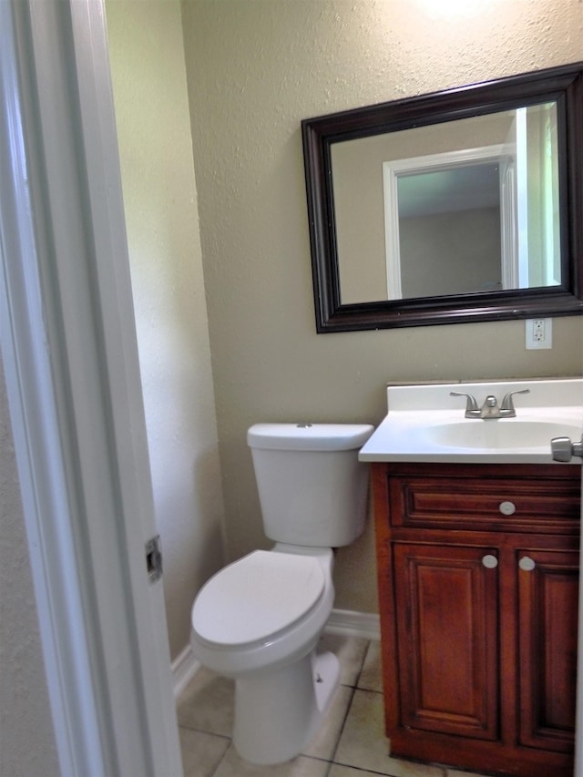 5335 Idylwood St, Beaumont, TX 77703 - bathroom with vanity, toilet, tile patterned floors, and baseboards