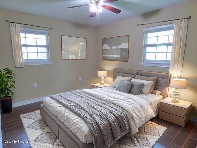 5335 Idylwood St, Beaumont, TX 77703 - bedroom featuring dark wood-type flooring, multiple windows, baseboards, and a ceiling fan