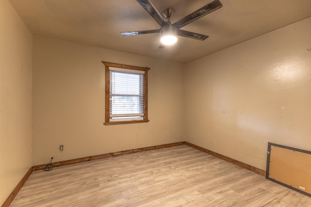 spare room with ceiling fan and light wood-type flooring