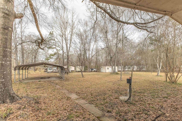 view of yard with a storage shed and a carport