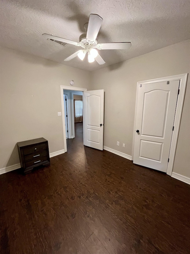 479 Reynolds Ln, Vidor, TX 77662 - unfurnished bedroom with baseboards, a textured ceiling, visible vents, and wood finished floors