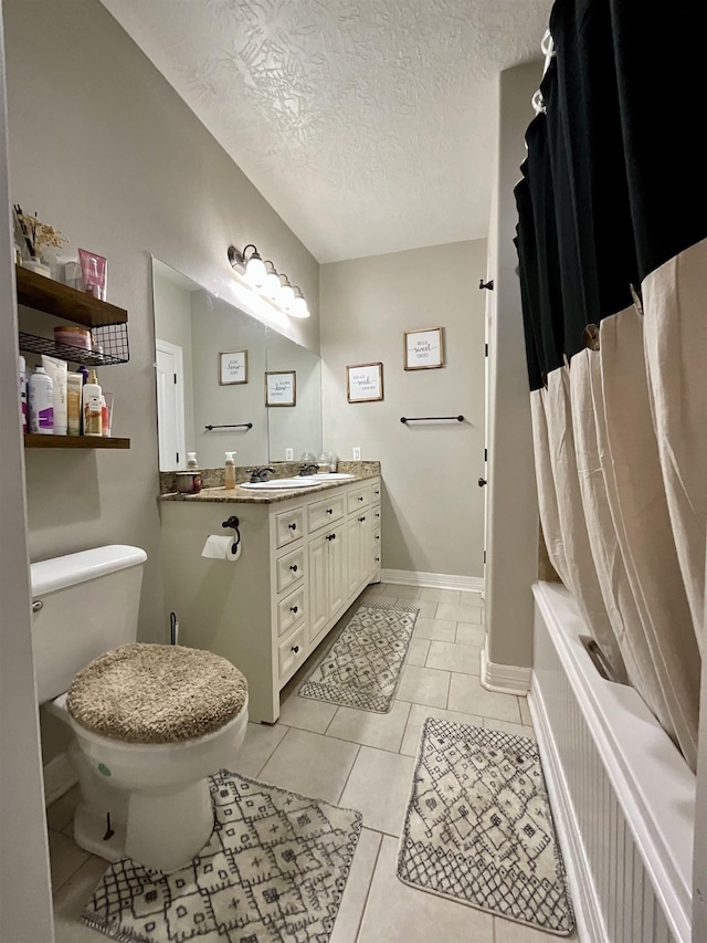 479 Reynolds Ln, Vidor, TX 77662 - full bathroom featuring tile patterned flooring, vanity, toilet, a textured ceiling, and shower / tub combo