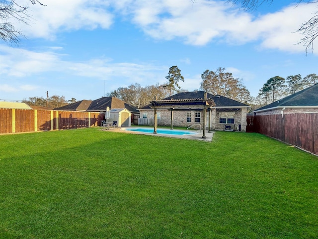 479 Reynolds Ln, Vidor, TX 77662 - view of yard featuring a fenced in pool, a fenced backyard, a shed, and an outbuilding