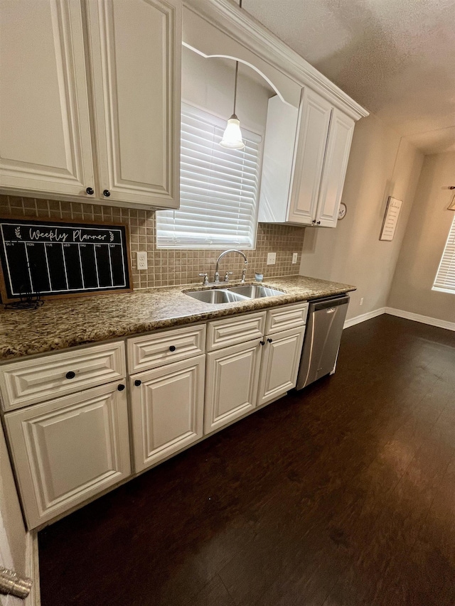 479 Reynolds Ln, Vidor, TX 77662 - kitchen with stainless steel dishwasher, decorative backsplash, baseboards, white cabinetry, and a sink