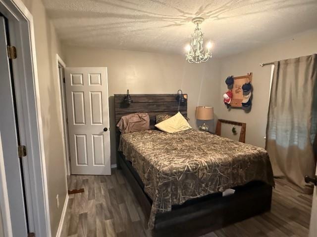 1445 Bahama Dr, Vidor, TX 77662 - bedroom with wood finished floors, a chandelier, and a textured ceiling