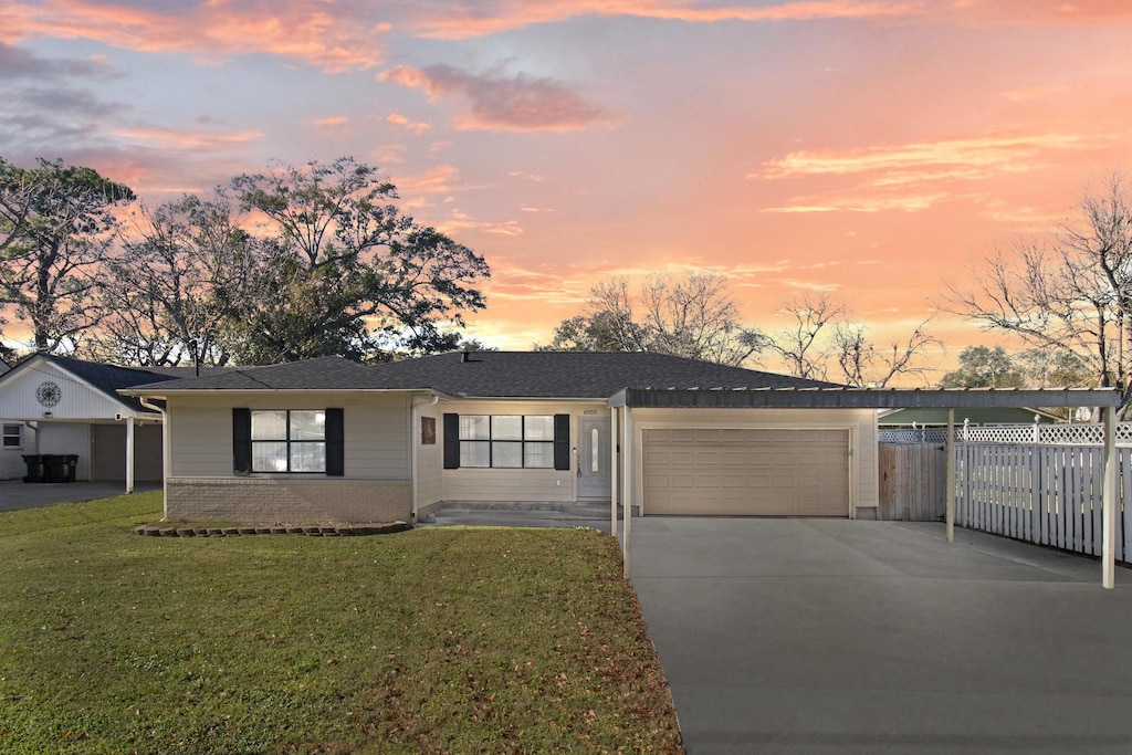 ranch-style house with a lawn and a garage