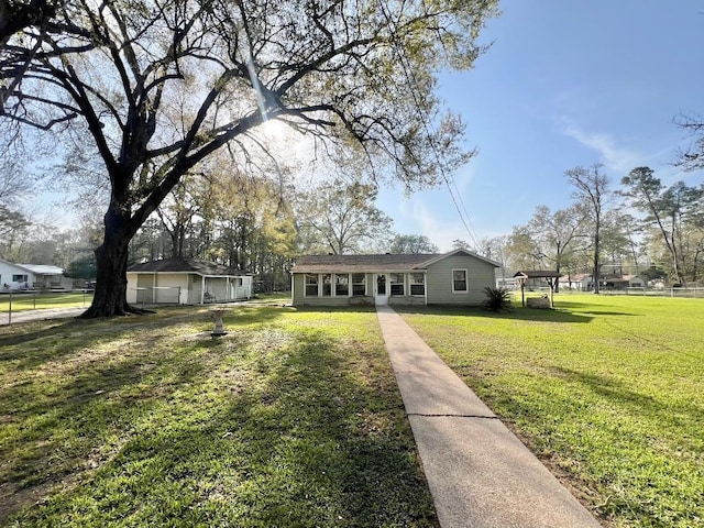 view of front of property with a front yard and fence