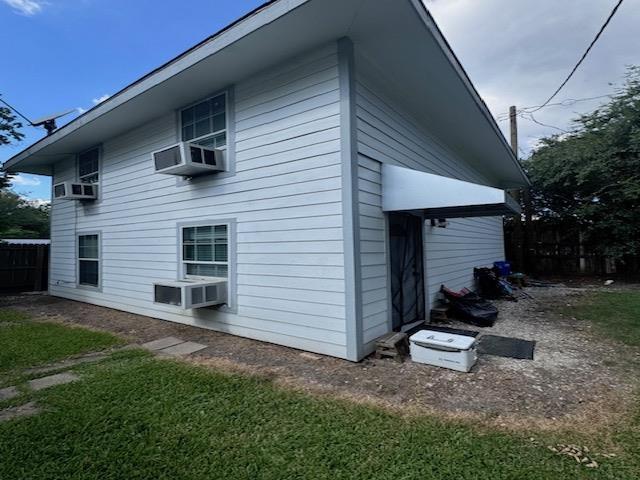 view of side of home featuring cooling unit