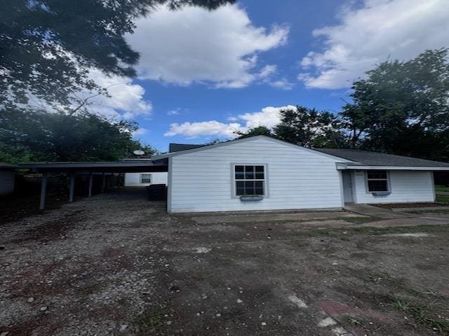 back of house with a carport