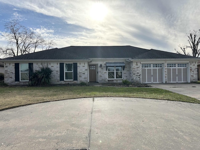 ranch-style house with a front lawn and a garage