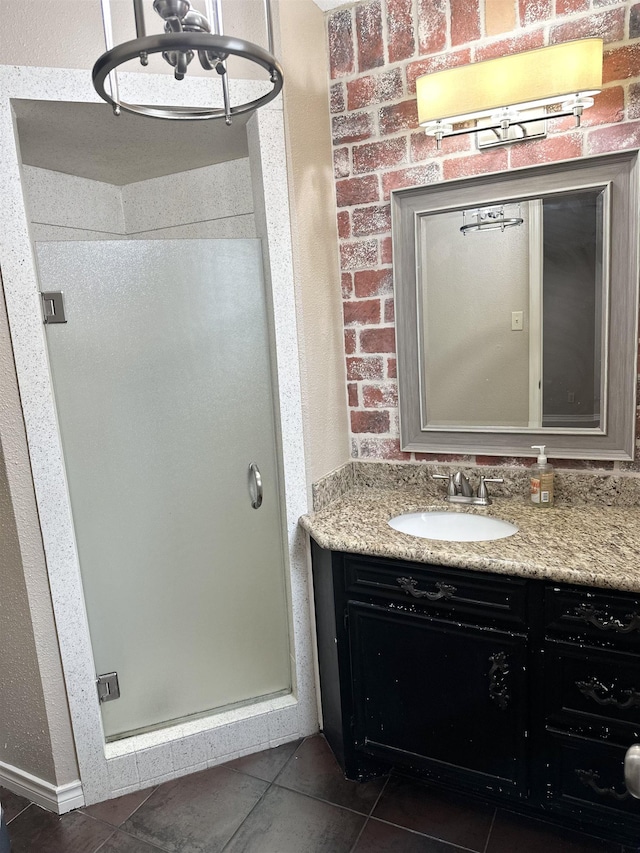 bathroom with tile patterned floors, a shower with shower door, and vanity