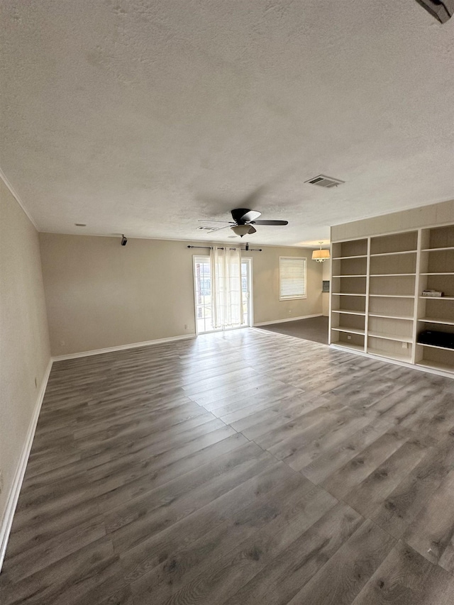 spare room with a textured ceiling and ceiling fan