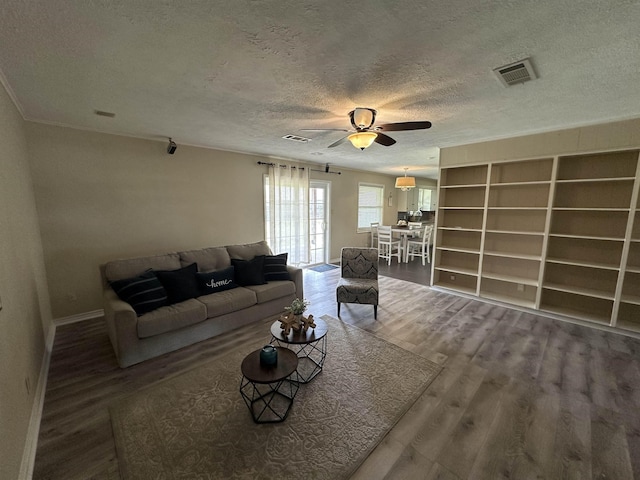 637 Ridgewood Dr, Port Neches, TX 77651 - living room featuring a textured ceiling, wood finished floors, and ceiling fan