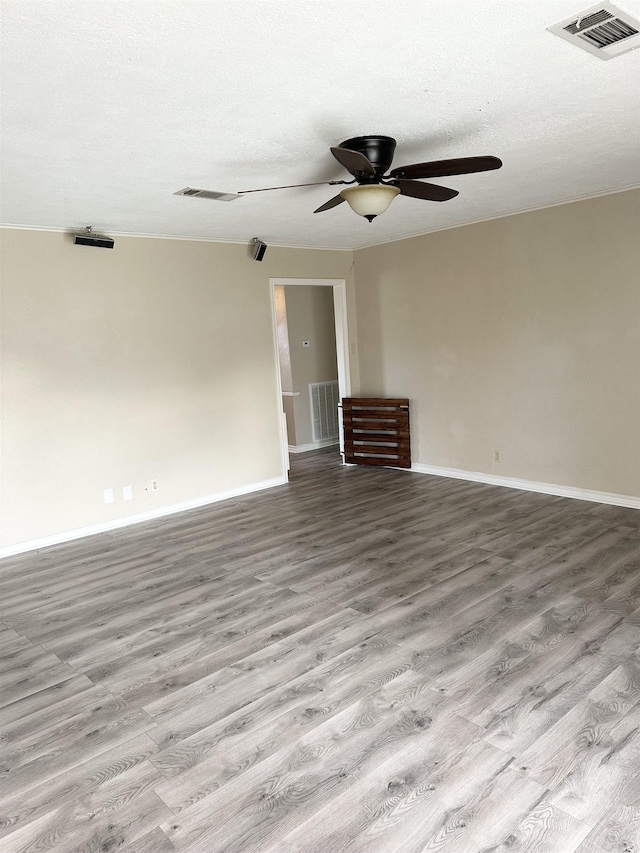 unfurnished room featuring light wood-type flooring, ceiling fan, and a textured ceiling