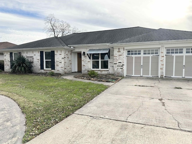 ranch-style house with a garage and a front yard