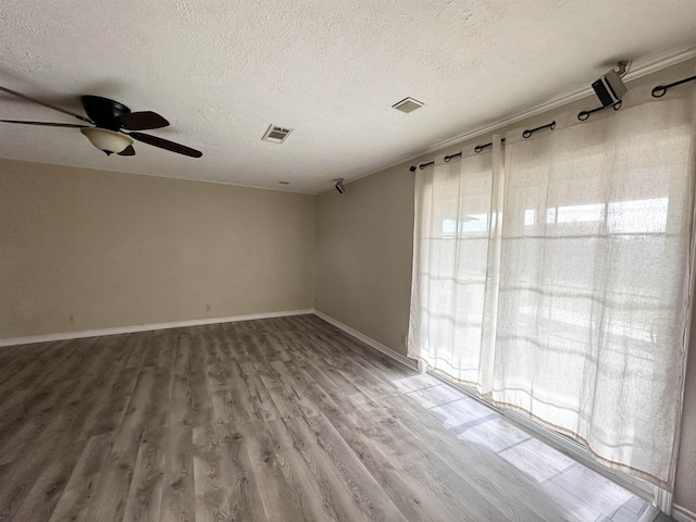 spare room featuring a textured ceiling, ceiling fan, and hardwood / wood-style flooring