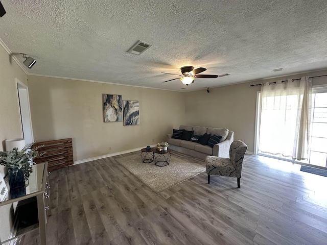 637 Ridgewood Dr, Port Neches, TX 77651 - living room featuring wood finished floors, a ceiling fan, a textured ceiling, and crown molding