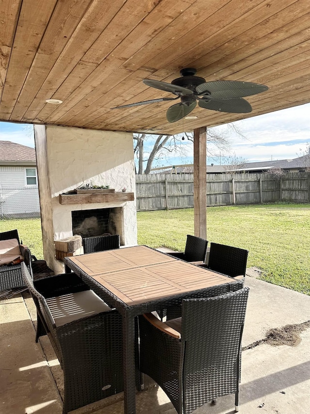 view of patio featuring exterior fireplace and ceiling fan